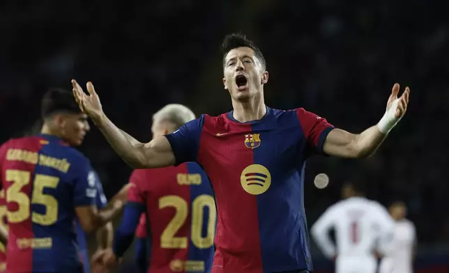 Barcelona's Robert Lewandowski celebrates after scoring his team's first goal during a Champions League phase soccer Matchday 5 between Barcelona and Brest at the Lluis Companys Olympic Stadium in Barcelona, Spain, Tuesday, Nov. 26, 2024. (AP Photo/Joan Monfort)