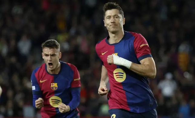 Barcelona's Robert Lewandowski celebrates after scoring his team's first goal during a Champions League phase soccer Matchday 5 between Barcelona and Brest at the Lluis Companys Olympic Stadium in Barcelona, Spain, Tuesday, Nov. 26, 2024. (AP Photo/Joan Monfort)