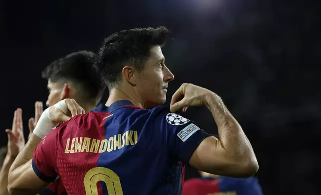 Barcelona's Robert Lewandowski celebrates after scoring his team's first goal during a Champions League phase soccer Matchday 5 between Barcelona and Brest at the Lluis Companys Olympic Stadium in Barcelona, Spain, Tuesday, Nov. 26, 2024. (AP Photo/Joan Monfort)