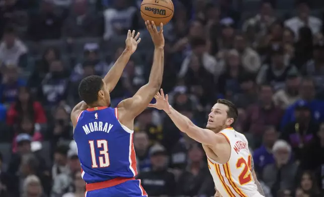 Sacramento Kings forward Keegan Murray (13) shoots over Atlanta Hawks guard Garrison Mathews during the first half of an NBA basketball game in Sacramento, Calif., Monday, Nov. 18, 2024. (AP Photo/Randall Benton)