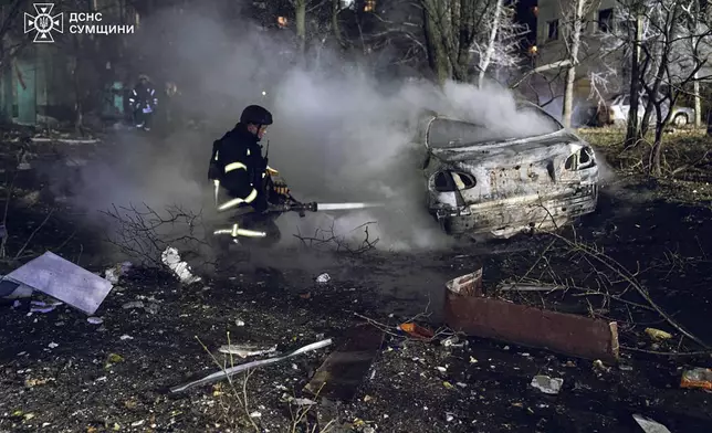 In this photo provided by the Ukrainian Emergency Service, firefighters extinguish the fire following a Russian rocket attack that hit a multi-storey apartment building in Sumy, Ukraine, Sunday, Nov. 17, 2024. (Ukrainian Emergency Service via AP)