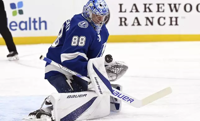 Tampa Bay Lightning goaltender Andrei Vasilevskiy (88) blocks a shot during the first period of an NHL hockey game against the Washington Capitals, Wednesday, Nov. 27, 2024, in Tampa, Fla. (AP Photo/Jason Behnken)