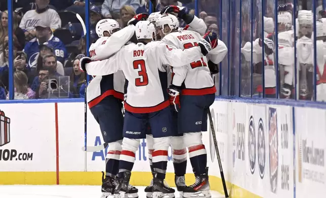 Washington Capitals celebrate a goal from center Aliaksei Protas (21) during the second period of an NHL hockey game against the Tampa Bay Lightning, Wednesday, Nov. 27, 2024, in Tampa, Fla. (AP Photo/Jason Behnken)