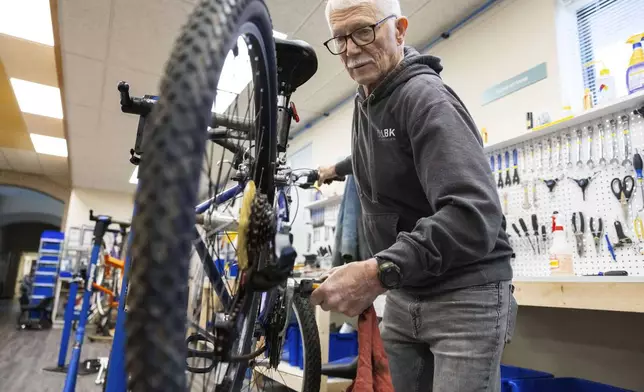 Volunteer Clayton Streich fixes a bicycle at Lincoln Bike Kitchen on Tuesday, Nov. 12, 2024, in Lincoln, Neb. (AP Photo/Rebecca S. Gratz)