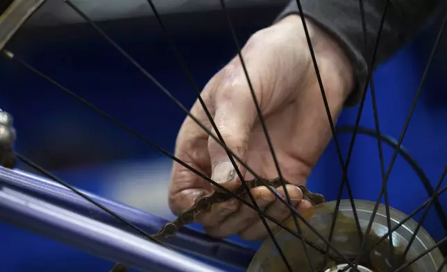 Volunteer Clayton Streich fixes a bicycle at Lincoln Bike Kitchen on Tuesday, Nov. 12, 2024, in Lincoln, Neb. (AP Photo/Rebecca S. Gratz)