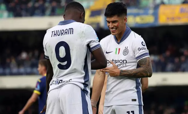 Inter Milan's Marcus Thuram, left, celebrates with his teammate Joaquin Correa after scoring during the Serie A soccer match between Hellas Verona and Inter Milan at the Marcantonio Bentegodi Stadium, in Verona, Italy, Saturday, Nov. 23, 2024. (Paola Garbuio/LaPresse via AP)