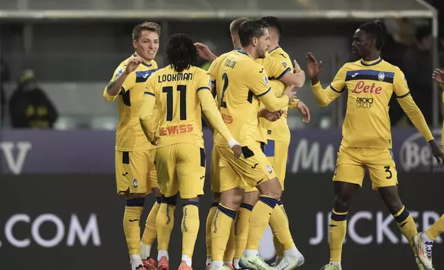Atalanta's Mateo Retegui, left, celebrates after scoring during the Italian Serie A soccer match between Parma and Atalanta at the Ennio Tardini Stadium in Parma, Italy, Saturday Nov. 23, 2024. (Massimo Paolone/LaPresse via AP)