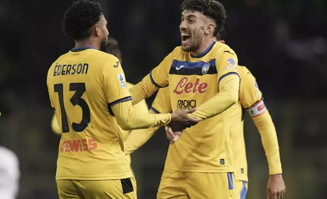 Atalanta's Ederson, left, celebrates after scoring during the Italian Serie A soccer match between Parma and Atalanta at the Ennio Tardini Stadium in Parma, Italy, Saturday Nov. 23, 2024. (Massimo Paolone/LaPresse via AP)