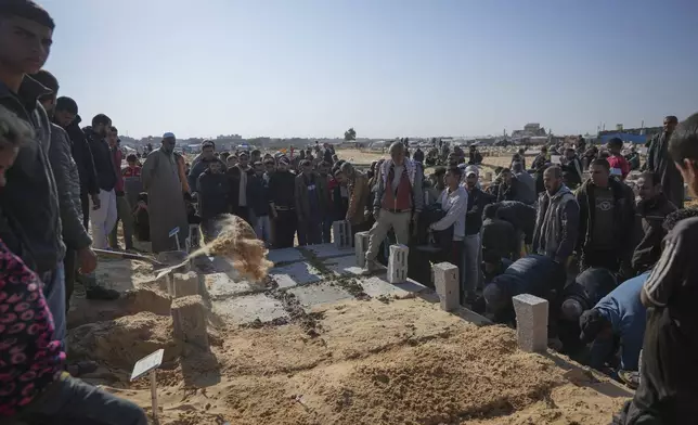 The graves of three children from the same family killed during an Israeli army strike are covered during their burial in Khan Younis, Gaza Strip, Thursday Nov. 21, 2024. Seven-year-old Hamza, his five-year-old brother Abdelaziz, and his four-year-old sister Laila Hassan were among 9 people killed by an Israeli strike in Khan Younis on Wednesday. Palestinian health officials say the death toll in the Gaza Strip from the 13-month-old war between Israel and Hamas has surpassed 44,000. (AP Photo/Abdel Kareem Hana)