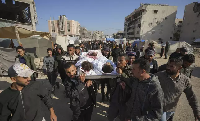 The bodies of three children are carried for burial in Khan Younis, Gaza Strip, Thursday Nov. 21, 2024. Seven-year-old Hamza, his five-year-old brother Abdelaziz, and his four-year-old sister Laila Hassan were among 9 people killed by an Israeli strike in Khan Younis on Wednesday. Palestinian health officials say the death toll in the Gaza Strip from the 13-month-old war between Israel and Hamas has surpassed 44,000. (AP Photo/Abdel Kareem Hana)