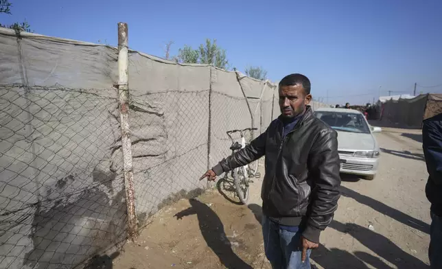 Mahmoud bin Hassan shows the spot where his three children were killed during an Israeli strike in Khan Younis, Gaza Strip, Thursday Nov. 21, 2024. Seven-year-old Hamza, his five-year-old brother Abdelaziz, and his four-year-old sister Laila Hassan were among 9 people killed by an Israeli strike in Khan Younis on Wednesday. Palestinian health officials say the death toll in the Gaza Strip from the 13-month-old war between Israel and Hamas has surpassed 44,000. (AP Photo/Abdel Kareem Hana)