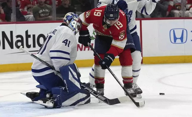 Toronto Maple Leafs goaltender Anthony Stolarz (41) defends the goal against Florida Panthers left wing Matthew Tkachuk (19) during the second period of an NHL hockey game, Wednesday, Nov. 27, 2024, in Sunrise, Fla. (AP Photo/Lynne Sladky)