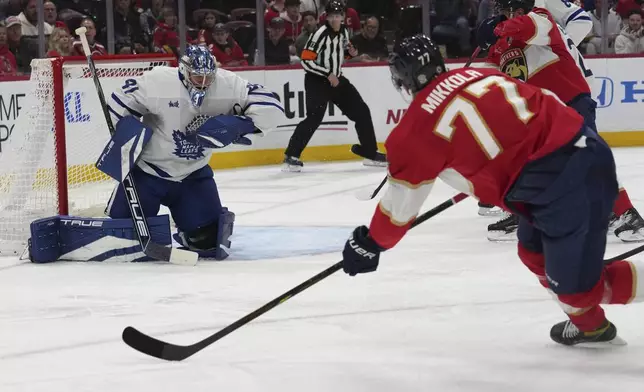 Toronto Maple Leafs goaltender Anthony Stolarz (41) defends a shot on the goal by Florida Panthers defenseman Niko Mikkola (77) during the second period of an NHL hockey game, Wednesday, Nov. 27, 2024, in Sunrise, Fla. (AP Photo/Lynne Sladky)