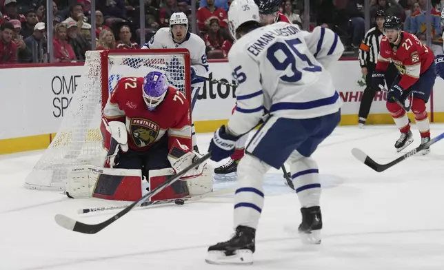 Florida Panthers goaltender Sergei Bobrovsky (72) defends the goal against Toronto Maple Leafs defenseman Oliver Ekman-Larsson (95) during the first period of an NHL hockey game, Wednesday, Nov. 27, 2024, in Sunrise, Fla. (AP Photo/Lynne Sladky)