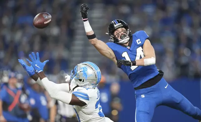 Detroit Lions safety Kerby Joseph reaches but is unable to catch a pass as Indianapolis Colts wide receiver Alec Pierce (14) defends during the first half of an NFL football game, Sunday, Nov. 24, 2024, in Indianapolis. (AP Photo/AJ Mast)