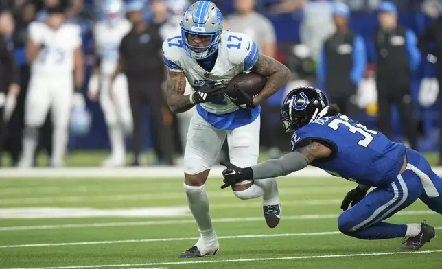 Detroit Lions wide receiver Tim Patrick (17) pulls away from Indianapolis Colts safety Julian Blackmon (32) during the second half of an NFL football game, Sunday, Nov. 24, 2024, in Indianapolis. (AP Photo/AJ Mast)