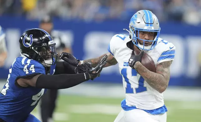 Detroit Lions wide receiver Tim Patrick (17) is pushed out of bounds by Indianapolis Colts linebacker Zaire Franklin (44) during the first half of an NFL football game, Sunday, Nov. 24, 2024, in Indianapolis. (AP Photo/Michael Conroy)