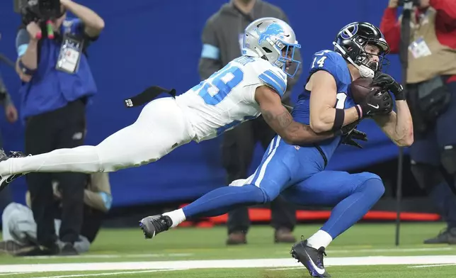 Detroit Lions cornerback Kindle Vildor (29) tackles Indianapolis Colts wide receiver Alec Pierce (14) during the first half of an NFL football game, Sunday, Nov. 24, 2024, in Indianapolis. (AP Photo/AJ Mast)