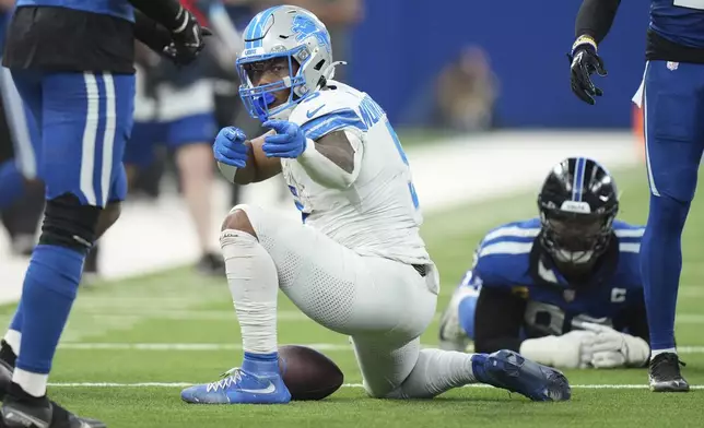 Detroit Lions running back David Montgomery (5) signals a first down during the second half of an NFL football game against the Indianapolis Colts, Sunday, Nov. 24, 2024, in Indianapolis. (AP Photo/AJ Mast)