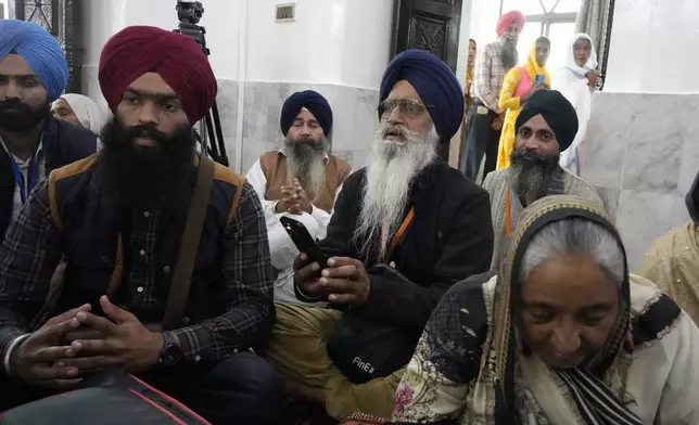 Sikh pilgrims attend their first Sikh guru, Guru Nanak Dev, birth anniversary celebrations at his shrine at the Gurdwara Darbar Sahib, in Kartarpur, Pakistan, Tuesday, Nov. 19, 2024. (AP Photo/Anjum Naveed)