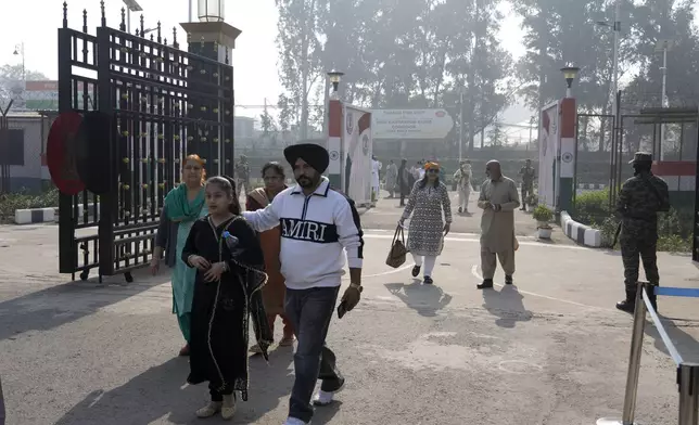 Indian Sikh pilgrims enter into Pakistan through Kartarpur border crossing point to attend the birth anniversary of their first Sikh guru, Guru Nanak Dev, at his shrine of Gurdwara Darbar Sahib, in Kartarpur, Pakistan, Tuesday, Nov. 19, 2024. (AP Photo/Anjum Naveed)