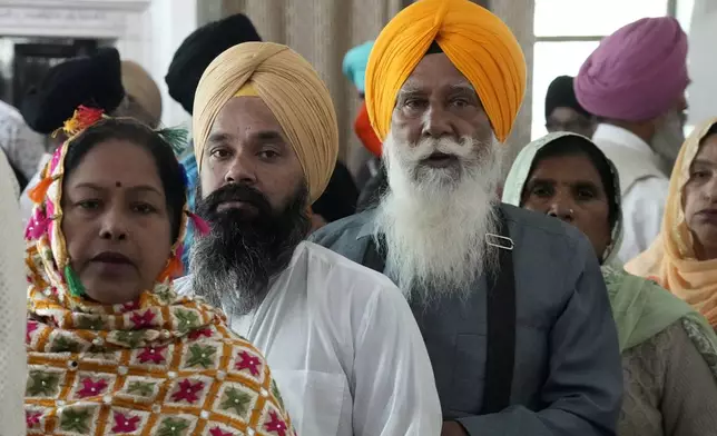 Sikh pilgrims attend their first Sikh guru, Guru Nanak Dev, birth anniversary celebrations at his shrine at the Gurdwara Darbar Sahib, in Kartarpur, Pakistan, Tuesday, Nov. 19, 2024. (AP Photo/Anjum Naveed)