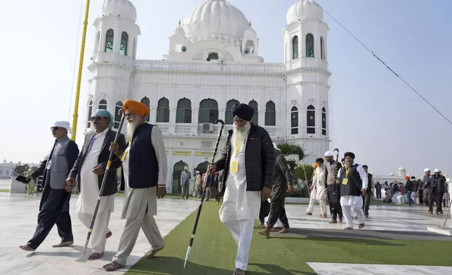 Sikh pilgrims attend their first Sikh guru, Guru Nanak Dev, birth anniversary celebrations at his shrine at the Gurdwara Darbar Sahib, in Kartarpur, Pakistan, Tuesday, Nov. 19, 2024. (AP Photo/Anjum Naveed)