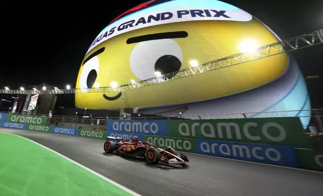 Ferrari driver Carlos Sainz, of Spain, drives past the Sphere during a practice session for the Formula One U.S. Grand Prix auto race, Thursday, Nov. 21, 2024, in Las Vegas. (AP Photo/Rick Scuteri)