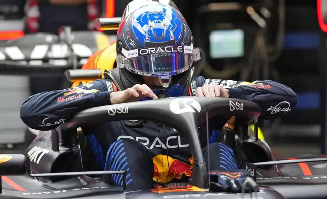 Red Bull driver Max Verstappen, of the Netherlands, gets in his car in the garage area during a practice session for the Formula One U.S. Grand Prix auto race, Thursday, Nov. 21, 2024, in Las Vegas. (AP Photo/Matt York)