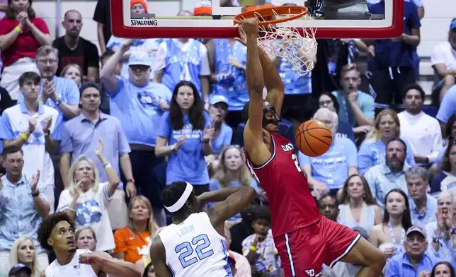 Dayton forward Zed Key dunks against North Carolina forward Ven-Allen Lubin (22) during the second half of an NCAA college basketball game at the Maui Invitational Monday, Nov. 25, 2024, in Lahaina, Hawaii. (AP Photo/Lindsey Wasson)