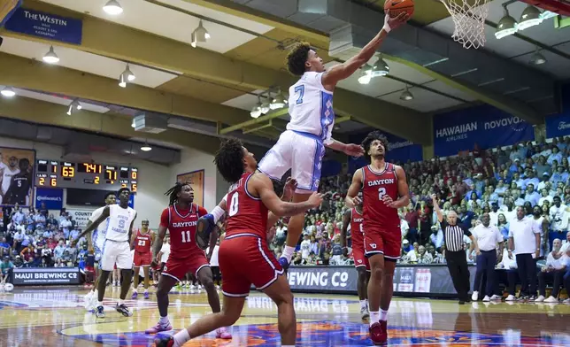 North Carolina guard Seth Trimble (7) goes up for a basket against Dayton guard Javon Bennett (0) and forward Nate Santos (2) during the second half of an NCAA college basketball game at the Maui Invitational Monday, Nov. 25, 2024, in Lahaina, Hawaii. (AP Photo/Lindsey Wasson)