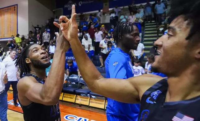 Memphis guard Tyrese Hunter, left, celebrates a 71-63 win against Michigan State with guard PJ Haggerty in an NCAA college basketball game at the Maui Invitational Tuesday, Nov. 26, 2024, in Lahaina, Hawaii. (AP Photo/Lindsey Wasson)