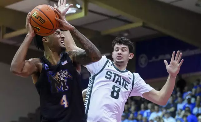 Memphis guard PJ Haggerty (4) looks around the defense of Michigan State forward Frankie Fidler during the first half of an NCAA college basketball game at the Maui Invitational Tuesday, Nov. 26, 2024, in Lahaina, Hawaii. (AP Photo/Lindsey Wasson)