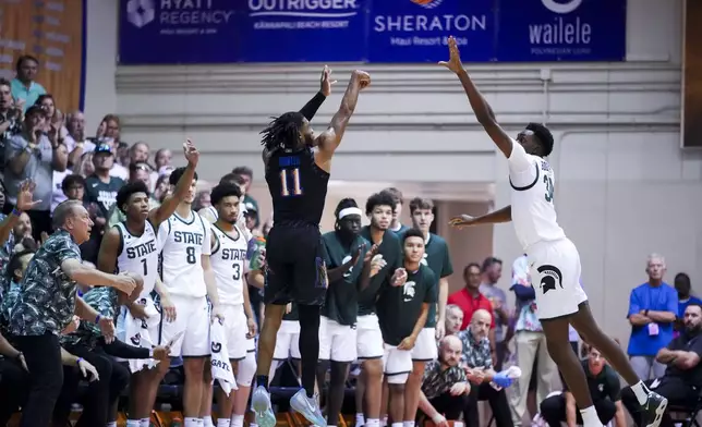 Memphis guard Tyrese Hunter (11) makes a basket against Michigan State forward Xavier Booker, right, during the first half of an NCAA college basketball game at the Maui Invitational Tuesday, Nov. 26, 2024, in Lahaina, Hawaii. (AP Photo/Lindsey Wasson)