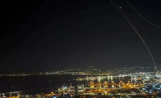 Israeli Iron Dome air defense system fires to intercept rockets that were launched from Lebanon, as seen from Haifa, northern Israel, early Saturday, Nov. 23, 2024. (AP Photo/Francisco Seco)