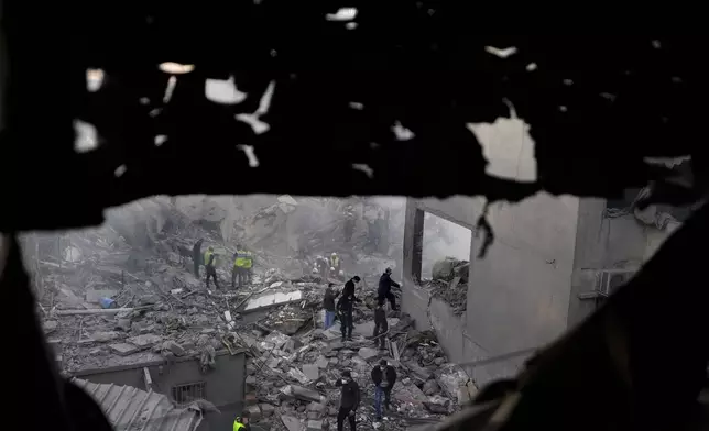 Rescue workers and people search for victims at the site of an Israeli airstrike that hit central Beirut, Lebanon, Saturday, Nov. 23, 2024. (AP Photo/Hassan Ammar)