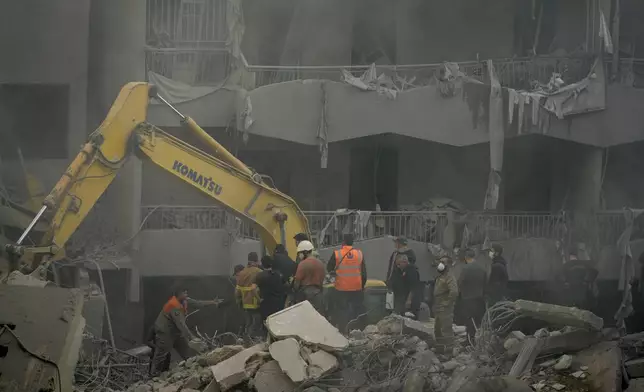 Rescue workers and people search for victims at the site of an Israeli airstrike that hit central Beirut, Lebanon, Saturday, Nov. 23, 2024. (AP Photo/Hassan Ammar)