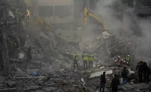 Rescue workers and people search for victims at the site of an Israeli airstrike that hit central Beirut, Lebanon, Saturday, Nov. 23, 2024. (AP Photo/Hassan Ammar)