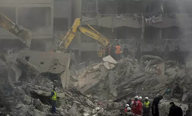 Rescue workers and people search for victims at the site of an Israeli airstrike that hit central Beirut, Lebanon, Saturday, Nov. 23, 2024. (AP Photo/Hassan Ammar)