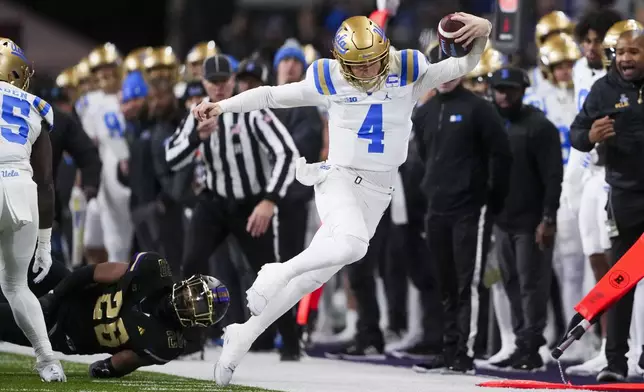 UCLA quarterback Ethan Garbers (4) runs the ball against Washington linebacker Khmori House (28) during the first half of an NCAA college football game Friday, Nov. 15, 2024, in Seattle. (AP Photo/Lindsey Wasson)