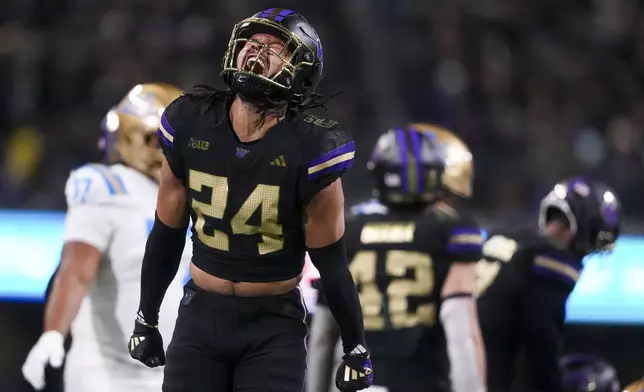 Washington safety Makell Esteen reacts after a tackle against UCLA during the first half of an NCAA college football game Friday, Nov. 15, 2024, in Seattle. (AP Photo/Lindsey Wasson)