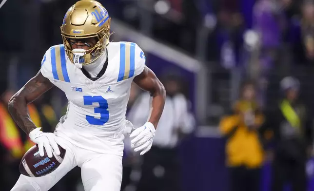 UCLA wide receiver Kwazi Gilmer (3) reacts to scoring a touchdown against Washington during the first half of an NCAA college football game Friday, Nov. 15, 2024, in Seattle. (AP Photo/Lindsey Wasson)