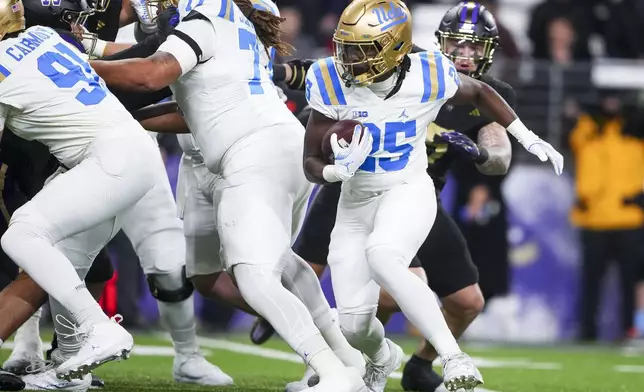 UCLA running back T.J. Harden (25) runs the ball against Washington during the first half of an NCAA college football game Friday, Nov. 15, 2024, in Seattle. (AP Photo/Lindsey Wasson)