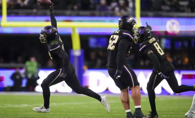 Washington defensive lineman Russell Davis II, left, reacts after recovering a fumble against UCLA during the first half of an NCAA college football game Friday, Nov. 15, 2024, in Seattle. (AP Photo/Lindsey Wasson)