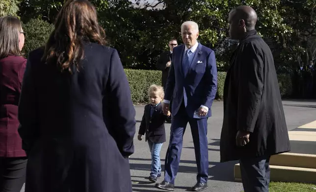 President Joe Biden, center right, departs with his grandson Beau Biden after pardoning the national Thanksgiving turkeys during a ceremony on the South Lawn of the White House in Washington, Monday, Nov. 25, 2024. (AP Photo/Mark Schiefelbein)