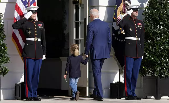 President Joe Biden, center right, departs with his grandson Beau Biden after pardoning the national Thanksgiving turkeys during a ceremony on the South Lawn of the White House in Washington, Monday, Nov. 25, 2024. (AP Photo/Mark Schiefelbein)