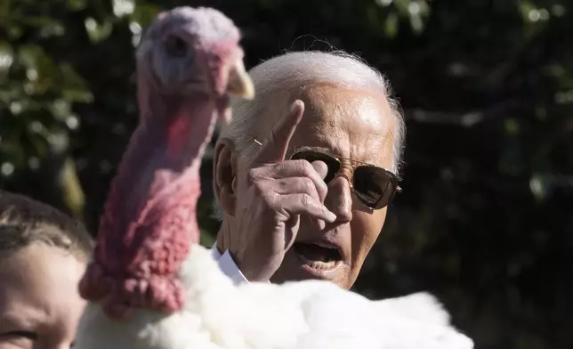 President Joe Biden pardons one of the national Thanksgiving turkeys, Peach, during a ceremony on the South Lawn of the White House in Washington, Monday, Nov. 25, 2024. (AP Photo/Mark Schiefelbein)