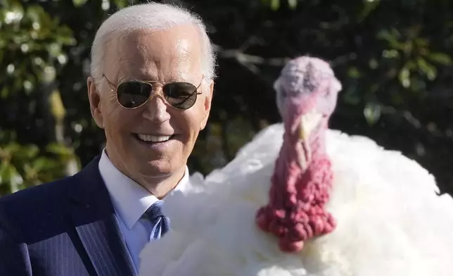 President Joe Biden speaks after pardoning the national Thanksgiving turkey, Peach, during a ceremony on the South Lawn of the White House in Washington, Monday, Nov. 25, 2024. (AP Photo/Mark Schiefelbein)