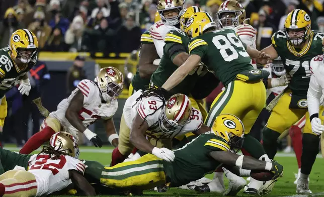 Green Bay Packers running back Josh Jacobs (8) stretches just short of a touchdown during the second half of an NFL football game against the San Francisco 49ers on Sunday, Nov. 24, 2024 in Green Bay, Wis. (AP Photo/Matt Ludtke)