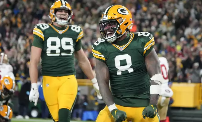 Green Bay Packers running back Josh Jacobs (8) celebrates a touchdown during the second half of an NFL football game against the San Francisco 49ers on Sunday, Nov. 24, 2024 in Green Bay, Wis. (AP Photo/Morry Gash)